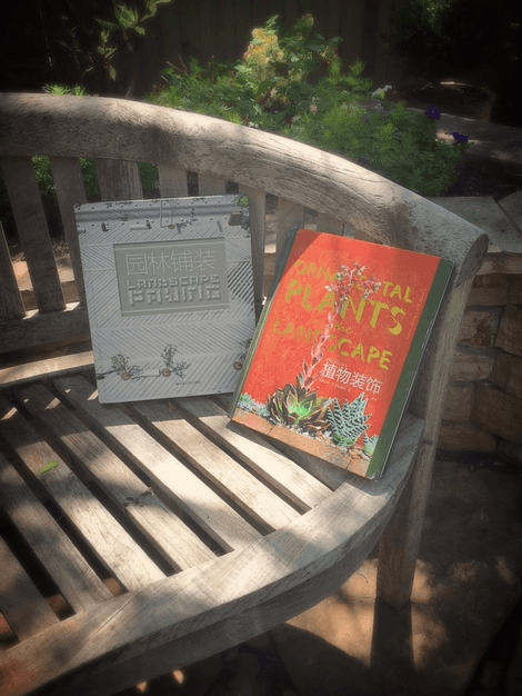 Two landscape design books on a wooden garden bench