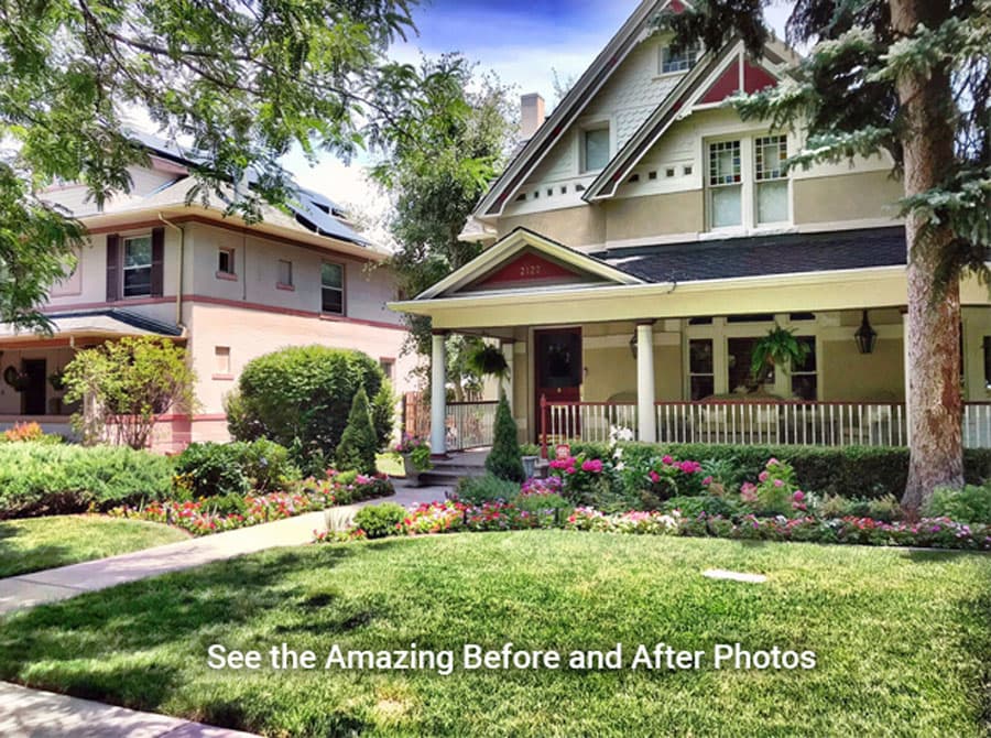 House with a columned front porch, lawn, and pink and red flower beds